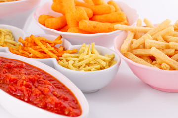 Potato, corn and wheat chips in bowls