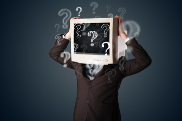 Businessman with a computer monitor head and question marks
