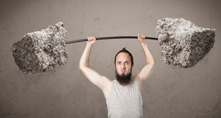 skinny guy lifting large rock stone weights