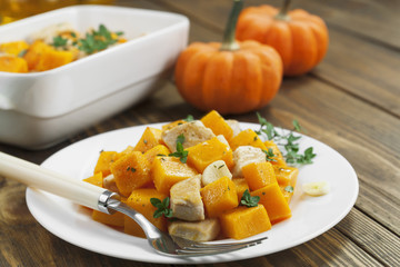 Baked pumpkin with chicken. garlic and herbs