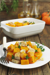 Baked pumpkin with chicken. garlic and herbs
