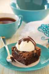 Chocolate brownie cake with a scoop of ice cream.