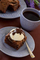 Chocolate brownie cake with a scoop of ice cream.
