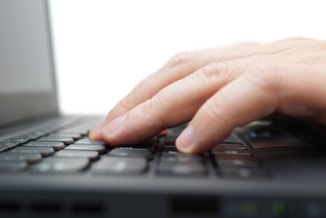 male  hands typing on a laptop