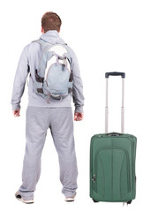 Back view of young man traveling with suitcas.