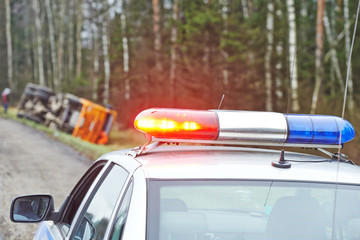 police car with a flasher at lorry crash