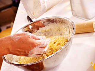 Female hand kneading dough.