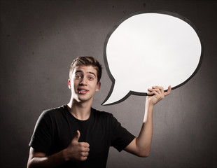 young man holding a speech bubble