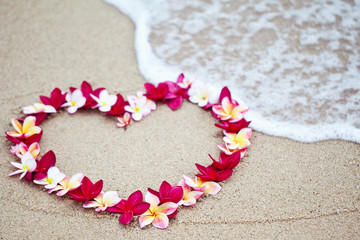 Flower love symbol on sand