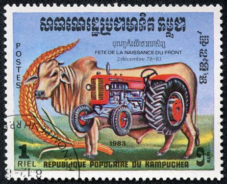 stamp printed by Kampuchea shows bull and tractor