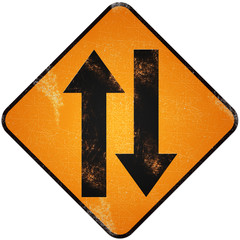 Two way traffic sign. Damaged yellow metallic road sign with Two