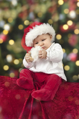 Obraz na płótnie Canvas little santa baby with christmas hat