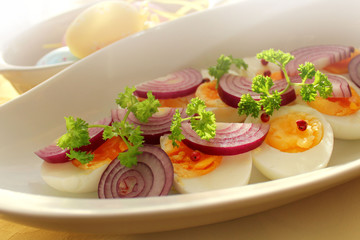 Boiled eggs with onion and herbs