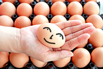 Egg on hands and smile face.