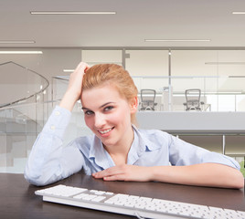 Business woman sitting at her desk - 58479507