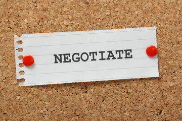 The word Negotiate on a cork notice board