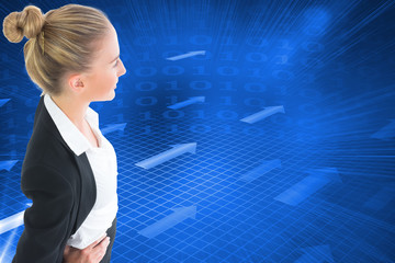 Composite image of businesswoman standing with hands on hips