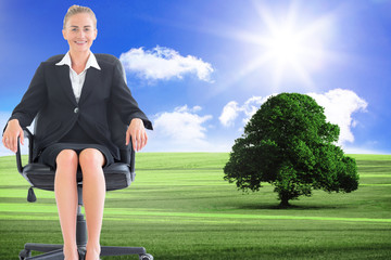 Composite image of businesswoman sitting on swivel chair in blac