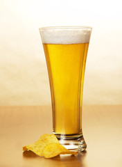 Glass of light beer and the golden chips