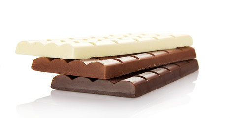 Stack of the porous white, black and milk chocolate