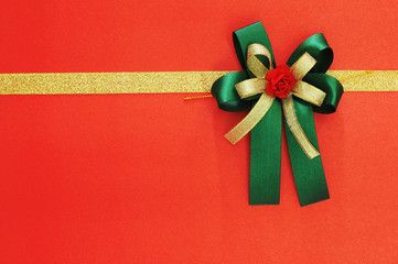 green bow and ribbon on red for background