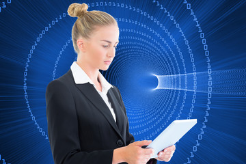 Composite image of businesswoman holding tablet