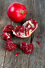 broken pomegranate on wooden surface