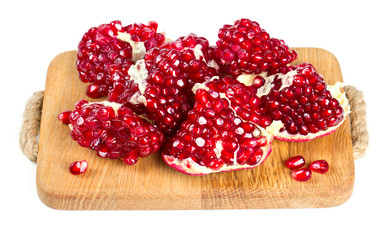 broken pomegranate on wooden board