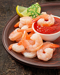 tails of shrimps with fresh lemon and rosemary in ceramic plate