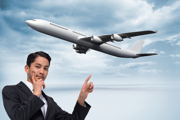 Fototapeta na wymiar Composite image of thoughtful asian businessman pointing