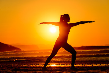 Fototapeta na wymiar Yoga and relax on beach at sunset