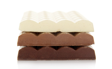 Stack of porous white, dark and milk chocolate