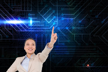 Composite image of smiling asian businesswoman pointing