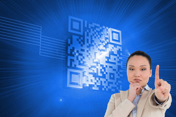 Composite image of thoughtful asian businesswoman pointing
