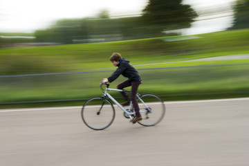 Fototapeta na wymiar Boy riding a bike in a park