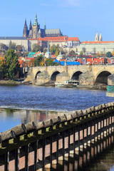Obraz premium Autumn Prague gothic Castle with Charles Bridge, Czech Republic