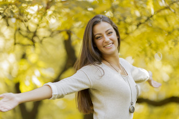 Young woman at the autumn forest