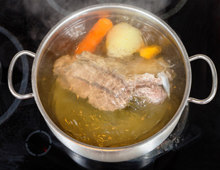 simmer of beef broth with seasoning vegetables