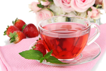 Delicious strawberry tea on table close-up