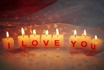 Candles with printed sign I LOVE YOU,on  color fabric