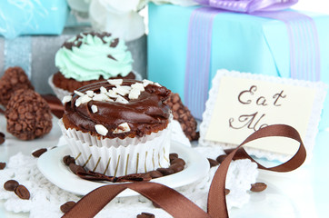 Tasty cupcake with gifts close up