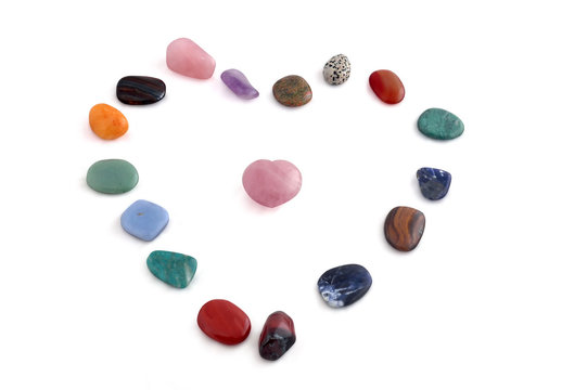 Small processed crystals in shape of heart on white background