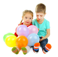Fototapeta na wymiar Little children with colorful balloons isolated on white