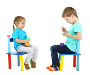 Little children playing with colorful tableware isolated