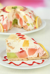 Delicious jelly cake on table on light background