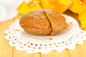 Delicious pumpkin pie on plate on wooden table close-up