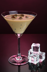 Baileys liqueur in glass on pink background
