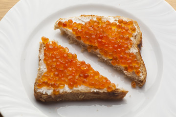 Sendwich with Caviar on bread decorated with rosemery
