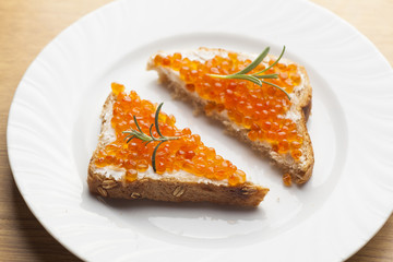 Sendwich with Caviar on bread decorated with rosemery