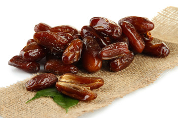 Dried dates on sackcloth isolated on white